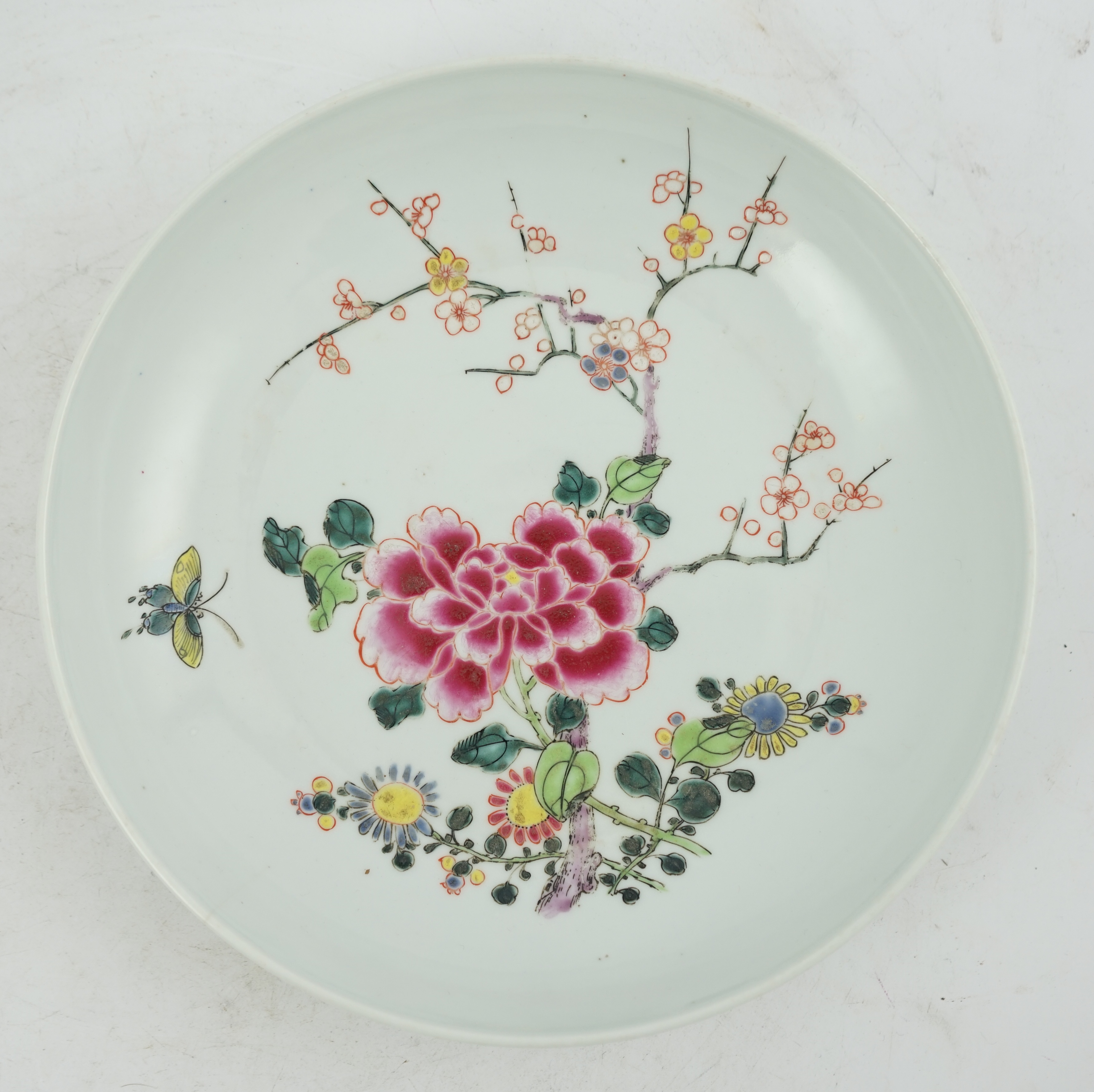 A Chinese famille rose ‘peony and prunus’ saucer dish, Yongzheng mark and period (1723-35)